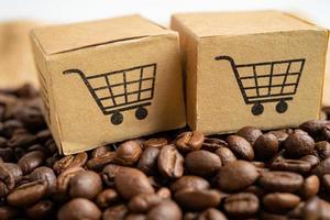 Box with shopping cart logo symbol on coffee beans, Import Export Shopping online or eCommerce delivery service store product shipping, trade, supplier concept. photo