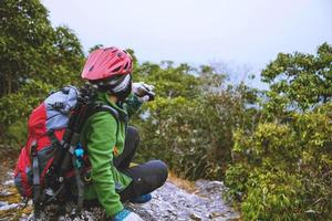 Asian women Travel photograph Nature. travel relax in the holiday walk in the forest. on a rocky cliff. Thailand photo