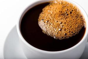 Coffee cup with bubbles isolated on white background. photo