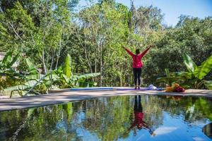 Summer holiday lifestyle woman relax near swimming pool, The concept of young women in yoga exercises, travel relax, Relax in the midst of nature. photo