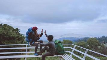 Asian couples travel nature on the mountains in winter.Travel relax. Natural touch countryside at doi inthanon in Thailand. photo