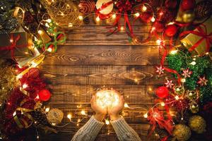 Christmas composition. Gifts, fir tree branches, decorations on a wooden background with copy space for your text. Christmas, winter new year concept. Led lights photo