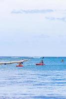 Red canoes on the sea panorama Playa del Carmen Mexico.