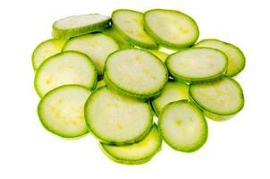 Round slices of young zucchini on white background. photo