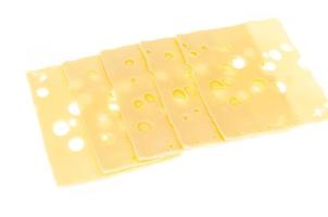 Slices of cheese with holes isolated on white background photo