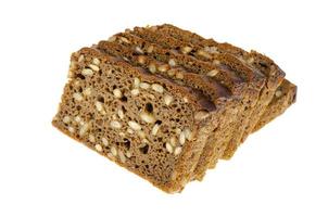 Slices of brown rye bread with sunflower seeds isolated on white background. photo