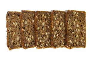Slices of brown rye bread with sunflower seeds isolated on white background. photo