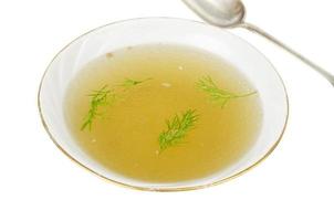 Plate with rich meat transparent broth with dill photo