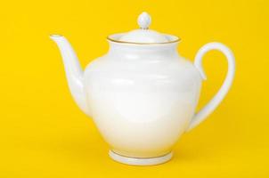 White teapot on bright background. Studio Photo