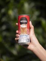 Jakarta, Indonesia, 2021 Hand holding Nescafe Cappuccino canned drink photo