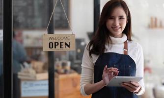 Portrait of Startup successful small business owner in coffee shop.handsome woman barista cafe owner. SME entrepreneur seller business concept photo