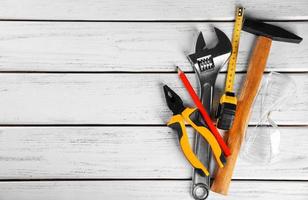 Set of tools on wooden background photo