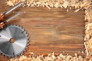 Flat lay composition with carpenter's tools and sawdust on wooden background photo