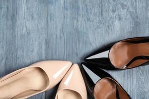 Female stylish shoes on wooden background, top view photo