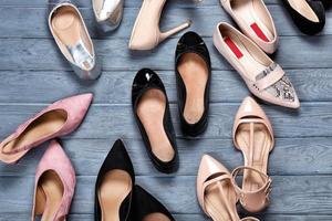 Female stylish shoes on wooden background, top view photo