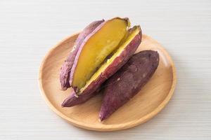 Grilled or baked Japanese sweet potatoes on wood plate photo