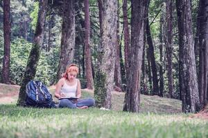 Women write notes Nature trails, mountains, forests. Writer photo