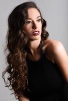 Brunette woman with long hair wearing black t-shirt photo