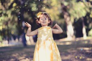 Little girl running and playing in the park photo