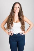 Woman with long hair wearing white t-shirt and blue jeans photo