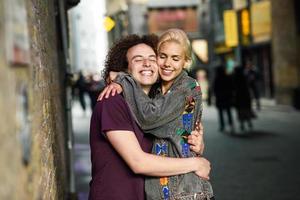 Young couple hugging in urban background on a typical London street. photo