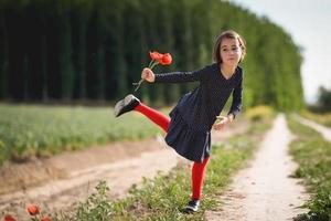 niña caminando en el campo de la naturaleza con un hermoso vestido foto