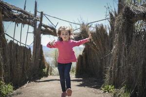 Little girl walking on a path of in a wetland