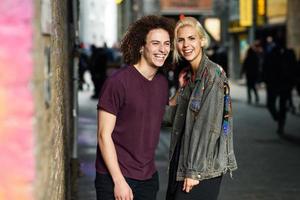 Young couple talking in urban background on a typical London street. photo