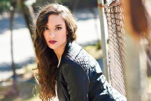 Girl with long hair wearing leather jacket photo