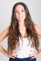 Woman with long hair wearing white t-shirt and blue jeans photo