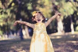 Little girl running and playing in the park photo