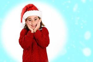 Adorable little girl wearing santa hat isolated on fantasy background photo