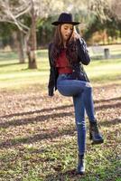 Portrait of young woman smiling in urban park photo