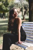 Pretty girl wearing black clothes in a park photo