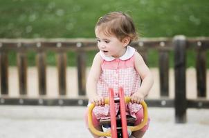 Little girl playing in a urban park photo