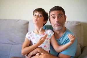 Little cute daughter doing make-up to her father photo