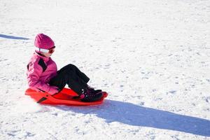 Little girl sledding at Sierra Nevada ski resort. photo