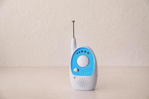 Baby monitor on table against light background. Radio nanny photo