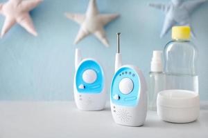 Baby monitors and different cosmetics on table photo