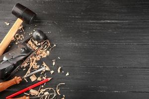 Set of carpenter's tools on wooden background photo