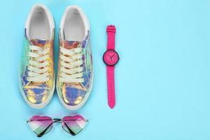 Casual female shoes and accessories on color background