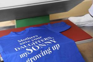 Modern printing machine with t-shirt at workplace photo