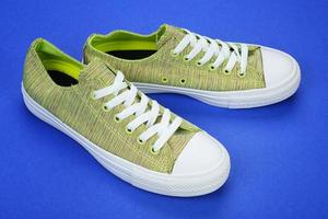 Casual female shoes on color background photo