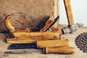 Old construction tools on a wooden workbench flat lay background photo