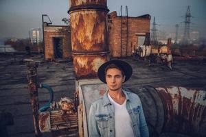 Urban man with hat against the background of city photo