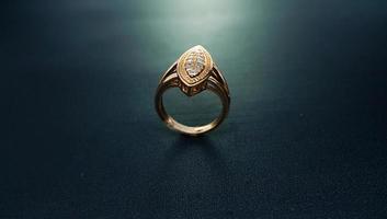 photo of women's diamond ring on a black background