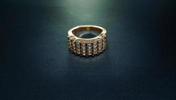 photo of women's ring that sparkles on a dark background