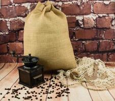 roasted Coffee beans and a vitage coffee grinder photo