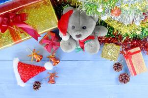 Christmas decorations with teedy doll and santa hat and gift box backgrounds above photo