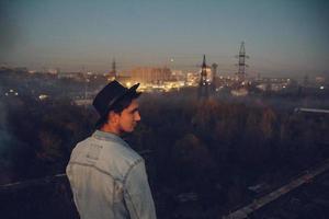 Urban man with hat against the background of city photo